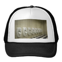 restroom interior with urinal row trucker hat