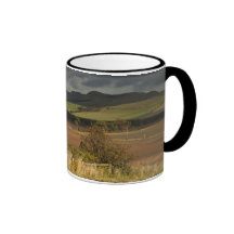 Rolling Hills And Mountains Under A Cloudy Sky Coffee Mugs