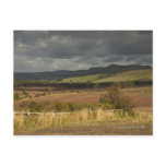 Rolling Hills And Mountains Under A Cloudy Sky Postcard