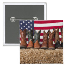Row of cowboy boots on haystack buttons