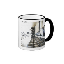 Row of free weights in foreground and exercise coffee mug