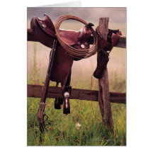 Saddle and lasso on fence greeting card