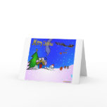 Santa_drops_gifts_by_snowman_and_snow_covered_hous Greeting Cards