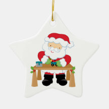 Santa in his workshop with toys star ornament