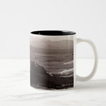 Sea waves crashing against rock mugs