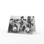 Seven rodeo cowgirls jokingly posing with a donkey cards