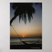 Silhuetted empty hammock at sunset posters