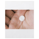 Single white pill in palm flyers