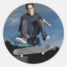 Skateboarder on a flip trick round stickers