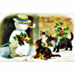 Snowman standing with holy leaves and cats around cut outs