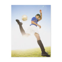 Soccer player jump kicking postcard