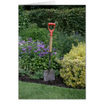 Spade in flower bed greeting card