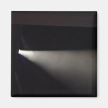 Spotlight against dark background fridge magnet