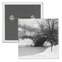 Stone bridge over snow covered river buttons