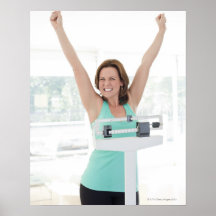 Successful weight loss. Happy woman weighing Print