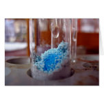 Test tube with blue chemical powder greeting card