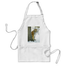 Tiger Cub In Snow Peeking Around Tree Aprons