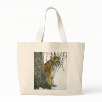 Tiger Cub In Snow Peeking Around Tree Bags