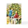 Tow kids playing under a christmas tree greeting cards