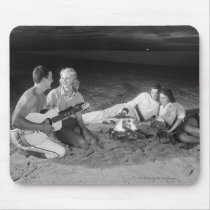 Two couples on beach sitting around campfire mousepads