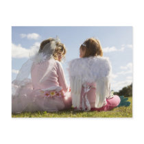 Two girls (7-9) dressed as angel and fairy postcards