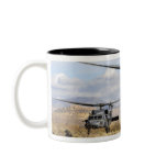 Two HH-60 Pavehawk helicopters preparing to lan Mug
