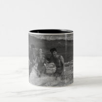 Two young men and woman playing in wave B&W mugs