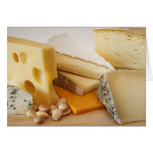 Various cheeses on chopping board cards