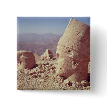 View of a colossal head and an eagle pin