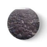 View over pebbles to silouetted West Pier buttons
