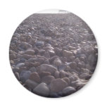 View over pebbles to silouetted West Pier magnets