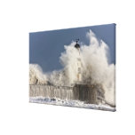 Waves Crashing Up Against A Lighthouse Canvas Print