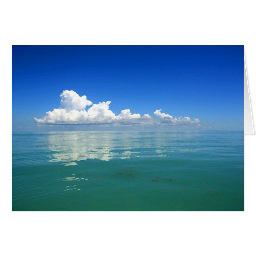 White cloud over a placid ocean card