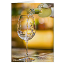 White wine is poured from bottle in restaurant. cards