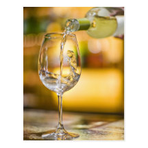 White wine is poured from bottle in restaurant. post card