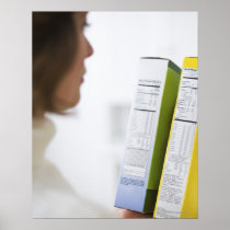 Woman comparing nutrition labels print