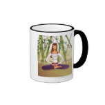 Woman sitting in lotus position, meditating coffee mugs