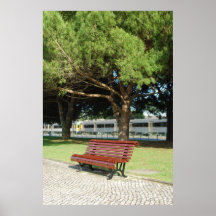 Wooden bench on a park and a train passing behind print