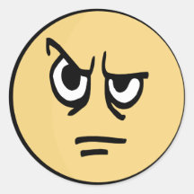Yellow smiley face that is aggravated. round sticker