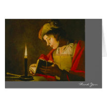 Young man reading by candlelight greeting cards