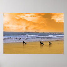 young surfers walking on sunset beach poster