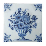 18th Century Dutch Delft Flower Arrangement Repro Tile<br><div class="desc">This blue and white tile features an overflowing urn of flowers with rather unusual corners. It dates to the mid-1700s. Available in 4.5 and 6 inch tiles as well as other items. Be sure to see our other Delft tiles - they look great when combined as a variety of accent...</div>