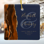 1st Christmas Married Burnt Orange Agate Navy Blue Ceramic Ornament<br><div class="desc">This elegant modern ornament features a burnt orange watercolor agate design trimmed with faux gold glitter. Easily customise the gold-coloured text on a navy blue background, with the names of the bride and groom in whimsical handwriting calligraphy over a large ampersand. The words "First Christmas Married" appear in serif font...</div>
