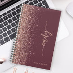 2025 Personalised Burgundy Rose Gold Glitter Planner<br><div class="desc">Personalise this elegant modern design with your name in vertical rose pink signature handwriting script on a burgundy background trimmed with a rose gold faux glitter border. Add the year in sans serif font. (To keep the swashes at the beginning and end of the name, replace only the letters, leaving...</div>