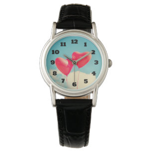 2 Bright Red Heart Shaped balloons Floating Upward Watch