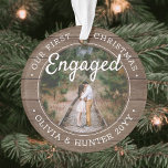 2 Photo Our 1st Christmas Engaged Rustic Faux Wood Ornament<br><div class="desc">Celebrate the joyful 1st holiday of your engagement with a custom 2 photo "Our First Christmas Engaged" round faux wood acrylic ornament. All wording and images on this template are simple to personalise and can be different or the same on front and back. (IMAGE & TEXT DESIGN TIPS: 1) To...</div>