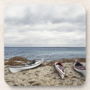 3 kayaks on beach coaster