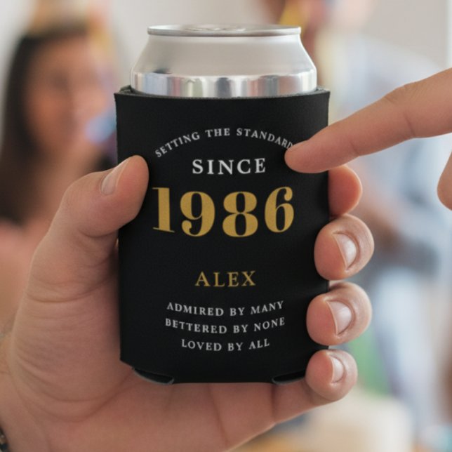 40th Birthday Name 1982 Black Gold Elegant Chic Can Cooler (40th Birthday black can cooler with 1986 held in a hand.)