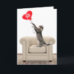 50th Birthday Cat With Heart Balloon Card<br><div class="desc">Tabby cat standing on a leather chair playing with a red heart balloon for 50th birthday.</div>