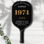 50th Birthday Name 1974 Black Gold Elegant Chic Pickleball Paddle<br><div class="desc">Chic '1974' 50th Birthday Black and Gold Personalised Pickleball Paddle - Elegant Design for Sports Enthusiasts. Celebrate a significant milestone in style with our chic '1974' 50th birthday black and gold pickleball paddle. Elegantly designed and fully personalised, this paddle blends birthday charm and utility in one. Ideal for anyone with...</div>